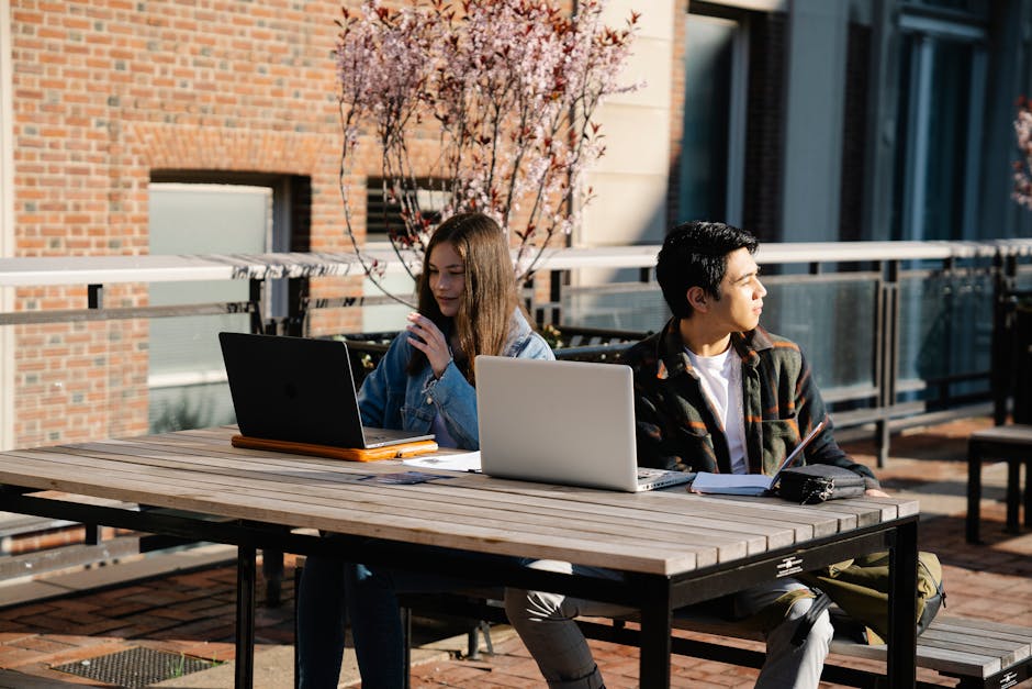 Osoba soustředěně studuje online kurz na svém notebooku v pohodlí domova.